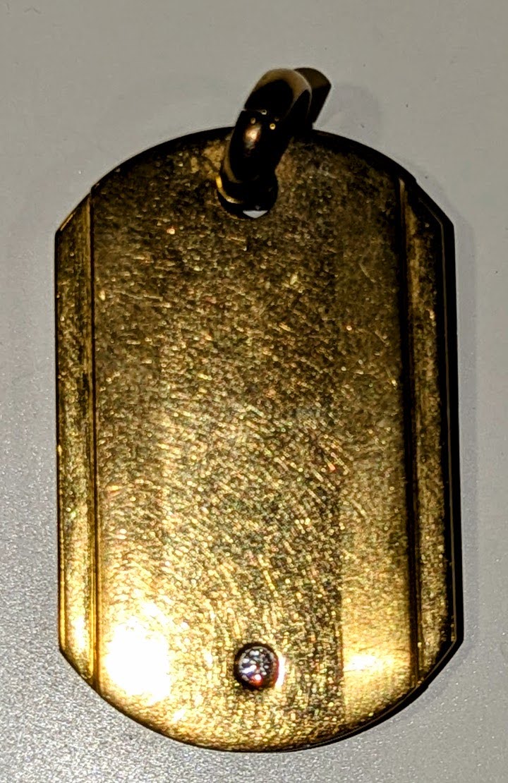 A gold-colored dogtag
